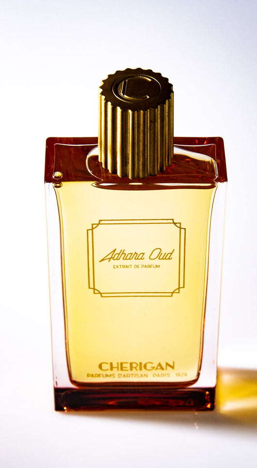 Adhara Oud 100ml bottle facing with the golden cap and the logo on top